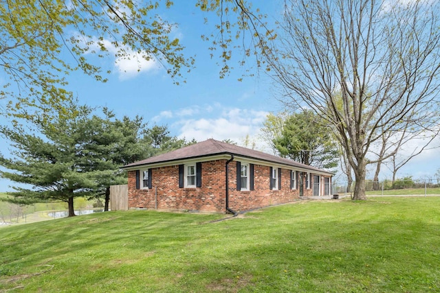 679 Mclain Rd, Springfield, KY 40069 - view of home's exterior with brick siding, a lawn, and fence
