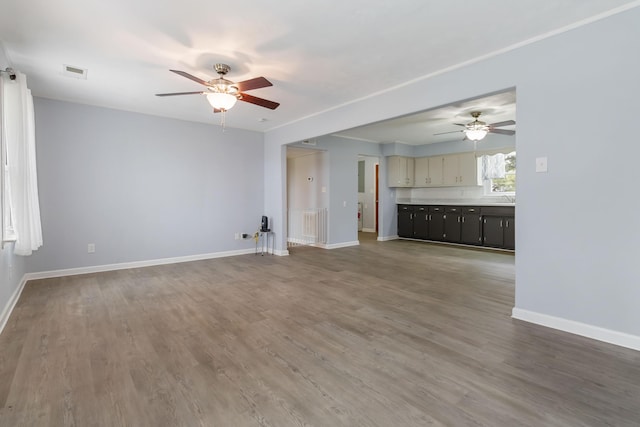 679 Mclain Rd, Springfield, KY 40069 - unfurnished living room featuring wood finished floors, visible vents, baseboards, and ceiling fan
