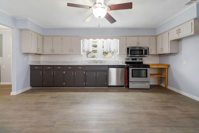 679 Mclain Rd, Springfield, KY 40069 - kitchen with a sink, light wood-type flooring, baseboards, light countertops, and appliances with stainless steel finishes