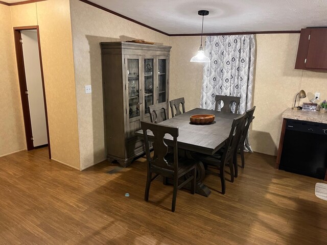 501 Smith Rd, Manchester, KY 40962 - dining room featuring dark wood-type flooring, vaulted ceiling, a textured wall, and ornamental molding