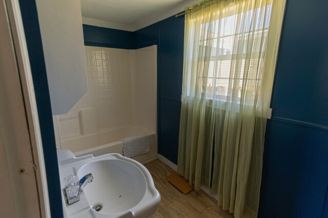 bathroom with shower / bath combination and a sink