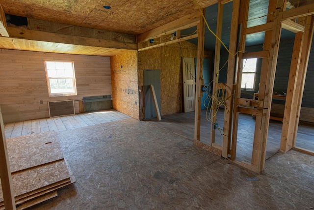 miscellaneous room featuring wood walls