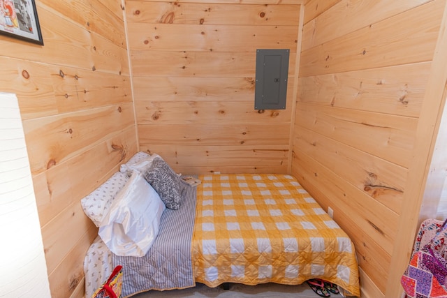 bedroom with wood walls, electric panel, and a sauna