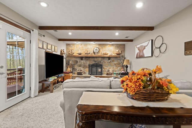 carpeted living room with recessed lighting, a stone fireplace, and beam ceiling