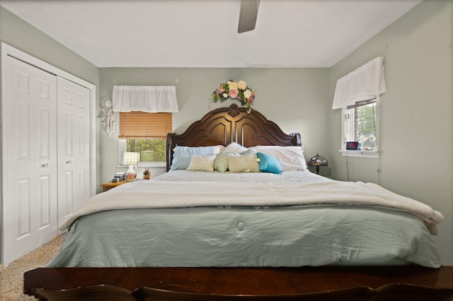 bedroom featuring a ceiling fan, carpet, a closet, and multiple windows