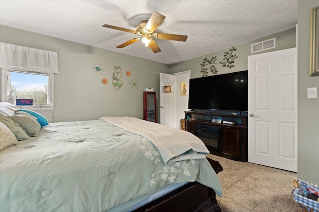 bedroom with a ceiling fan, carpet flooring, and visible vents