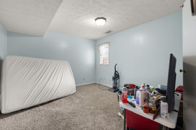 miscellaneous room featuring baseboards, visible vents, carpet floors, and a textured ceiling