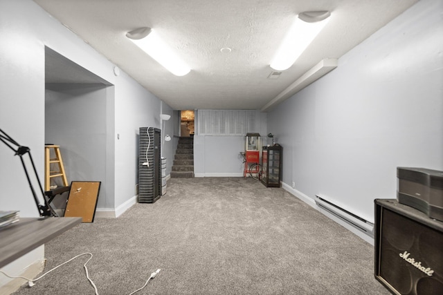 finished below grade area featuring a baseboard heating unit, a textured ceiling, baseboards, carpet, and stairway