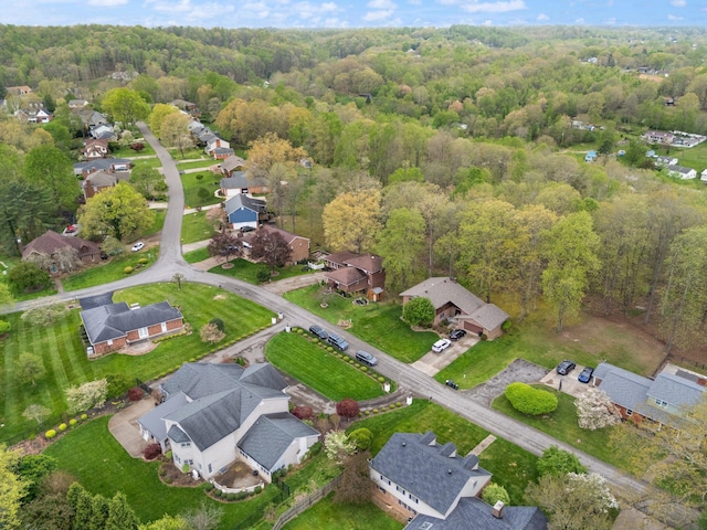 birds eye view of property featuring a forest view and a residential view