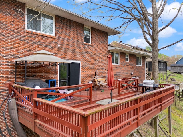 deck featuring grilling area, a gazebo, and outdoor dining space