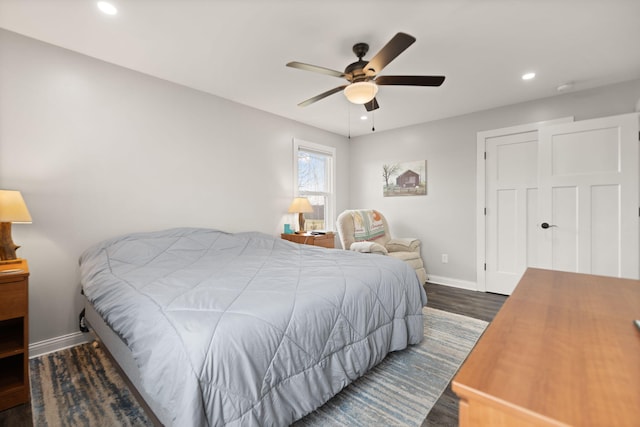 bedroom with wood finished floors, baseboards, recessed lighting, and ceiling fan