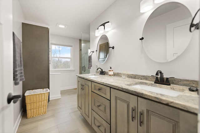 bathroom featuring baseboards, a sink, and double vanity