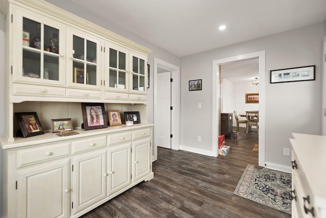 interior space featuring recessed lighting, dark wood finished floors, and baseboards