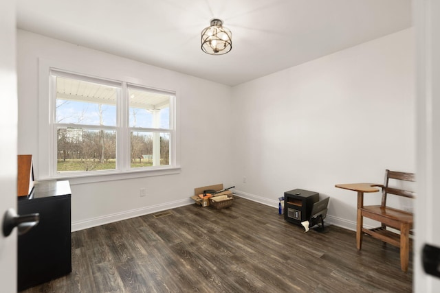 spare room featuring wood finished floors and baseboards