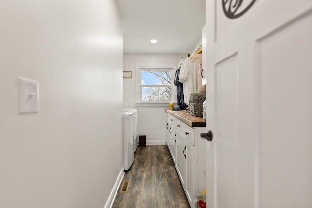 interior space featuring baseboards, recessed lighting, wood finished floors, independent washer and dryer, and vanity
