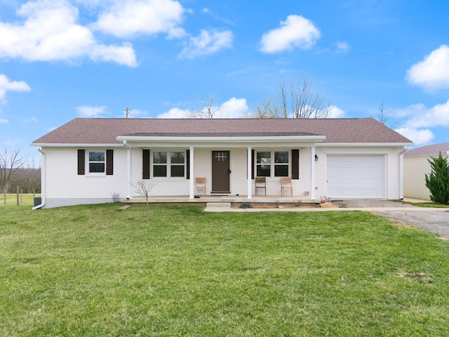 ranch-style home featuring a front lawn, driveway, covered porch, and a garage