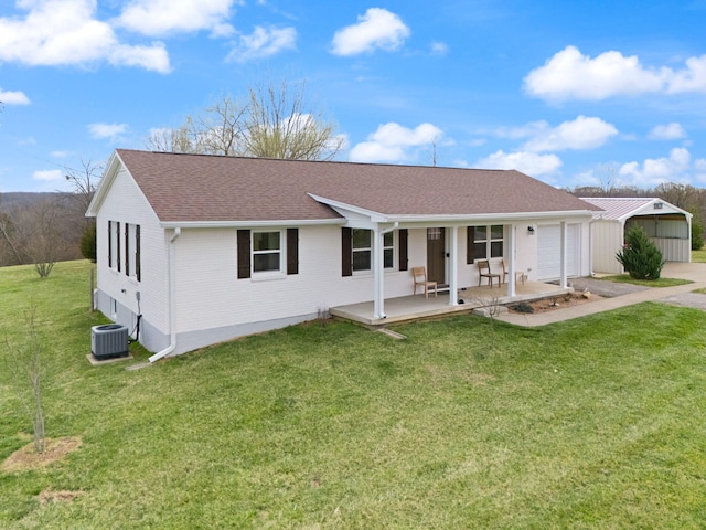 rear view of property with a yard, central air condition unit, an attached garage, a porch, and roof with shingles