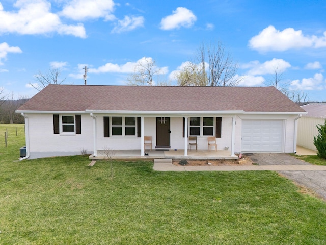 ranch-style home featuring a front lawn, driveway, covered porch, and a garage