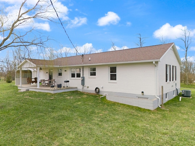 back of property with a yard, a patio area, and central AC unit
