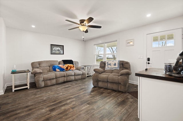 living area featuring dark wood-type flooring, a ceiling fan, baseboards, and recessed lighting