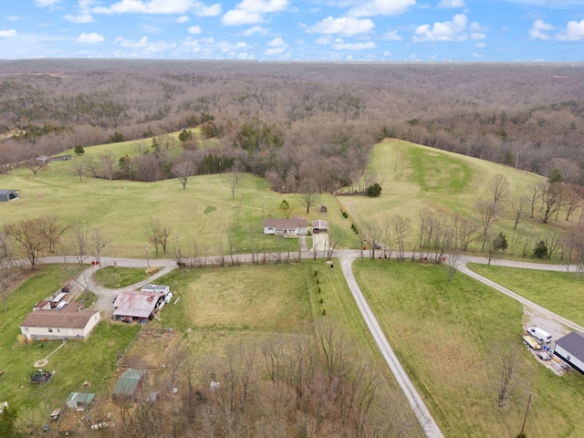 bird's eye view featuring a view of trees and a rural view