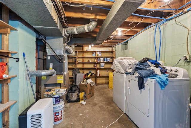 unfinished below grade area with washer and clothes dryer and concrete block wall