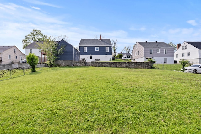 view of yard featuring a residential view and fence