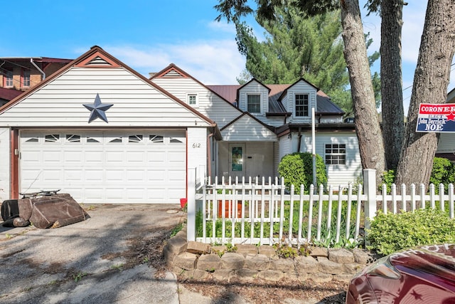 612 S Main St, Harlan, KY 40831 - view of front of house featuring a garage, driveway, and fence