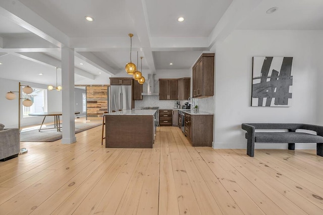 813 Westchester Dr, Lexington, KY 40502 - kitchen with a breakfast bar, light countertops, wall chimney range hood, built in refrigerator, and dark brown cabinetry