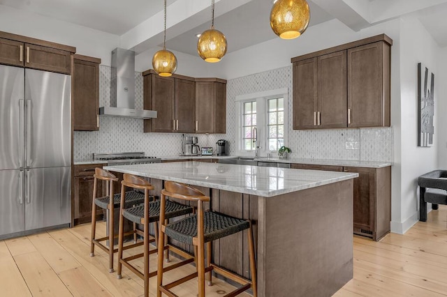 813 Westchester Dr, Lexington, KY 40502 - kitchen featuring high end fridge, a sink, wall chimney exhaust hood, a center island, and decorative backsplash