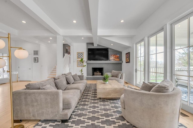 813 Westchester Dr, Lexington, KY 40502 - living room featuring recessed lighting, visible vents, a fireplace, light wood-style flooring, and stairs