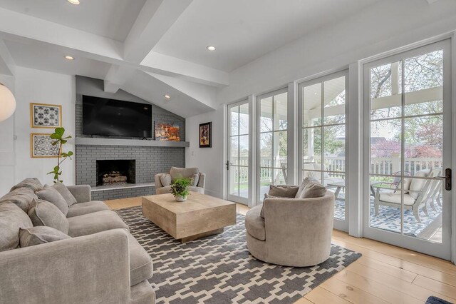 813 Westchester Dr, Lexington, KY 40502 - living area with beamed ceiling, plenty of natural light, a brick fireplace, and wood finished floors