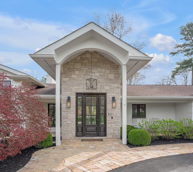 813 Westchester Dr, Lexington, KY 40502 - view of exterior entry featuring stone siding and a shingled roof