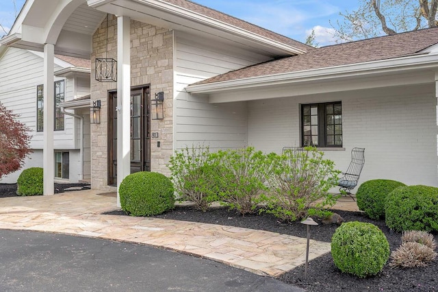813 Westchester Dr, Lexington, KY 40502 - doorway to property with stone siding and a shingled roof