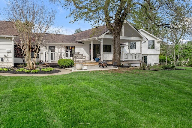 813 Westchester Dr, Lexington, KY 40502 - view of front of house featuring roof with shingles, a patio area, an outdoor fire pit, and a front yard