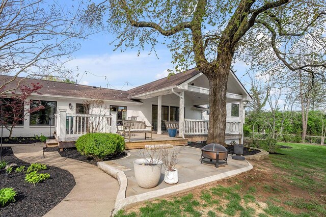 813 Westchester Dr, Lexington, KY 40502 - back of house featuring a fire pit, roof with shingles, a deck, and a patio