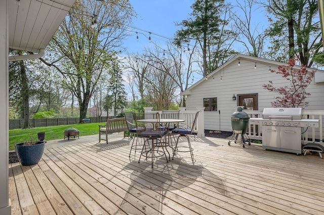 813 Westchester Dr, Lexington, KY 40502 - wooden deck with a fenced backyard, a fire pit, a lawn, area for grilling, and outdoor dining area