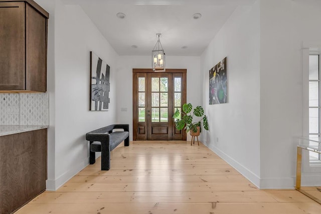 813 Westchester Dr, Lexington, KY 40502 - doorway to outside with light wood-style flooring, baseboards, and a chandelier