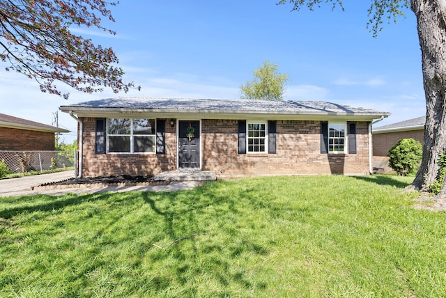 ranch-style home with a front lawn and brick siding