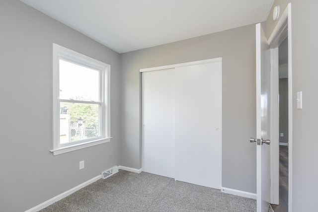 3241 Bowie Dr, Lexington, KY 40517 - unfurnished bedroom featuring baseboards, visible vents, carpet, and a closet