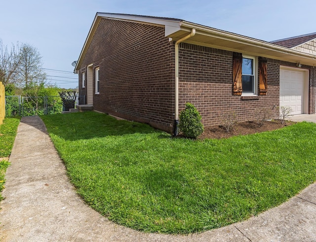3241 Bowie Dr, Lexington, KY 40517 - view of side of home featuring a lawn, an attached garage, fence, and brick siding