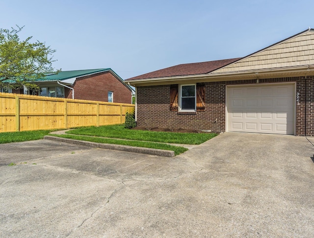 3241 Bowie Dr, Lexington, KY 40517 - exterior space with fence, an attached garage, driveway, and brick siding