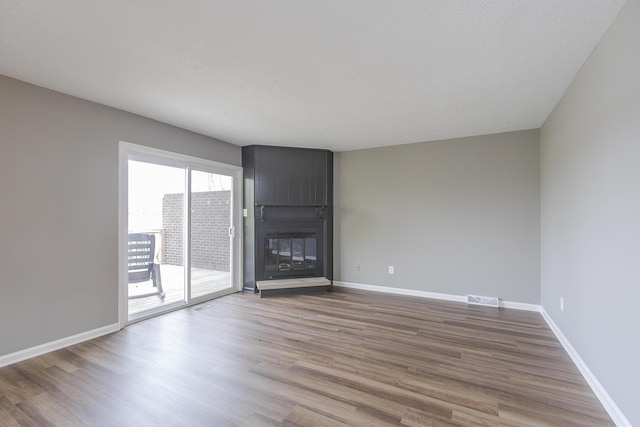 3241 Bowie Dr, Lexington, KY 40517 - unfurnished living room with baseboards, wood finished floors, visible vents, and a fireplace