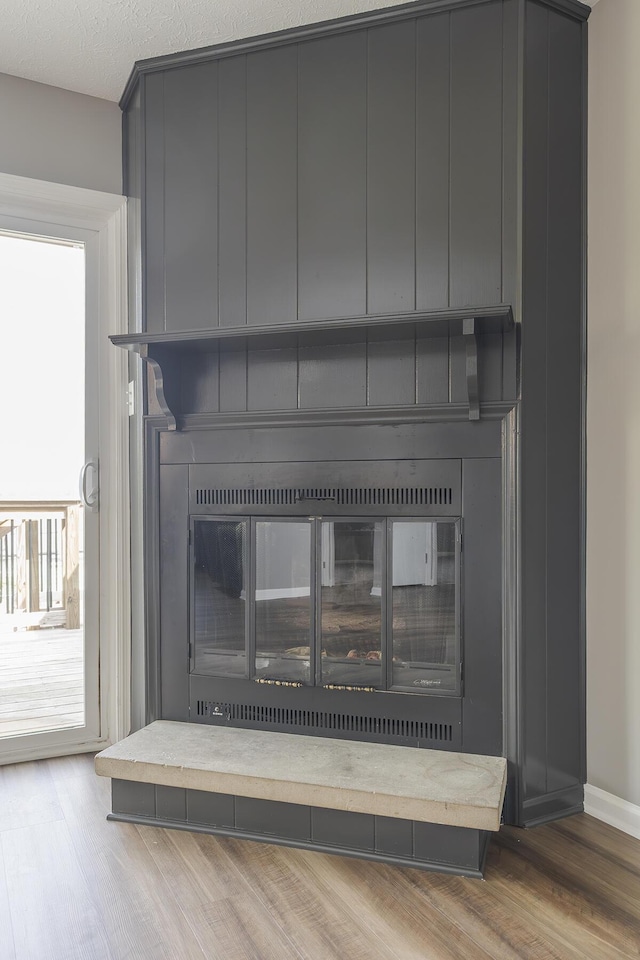 3241 Bowie Dr, Lexington, KY 40517 - room details featuring baseboards, wood finished floors, and a large fireplace