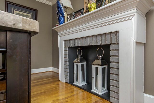 details featuring baseboards, wood finished floors, and ornamental molding
