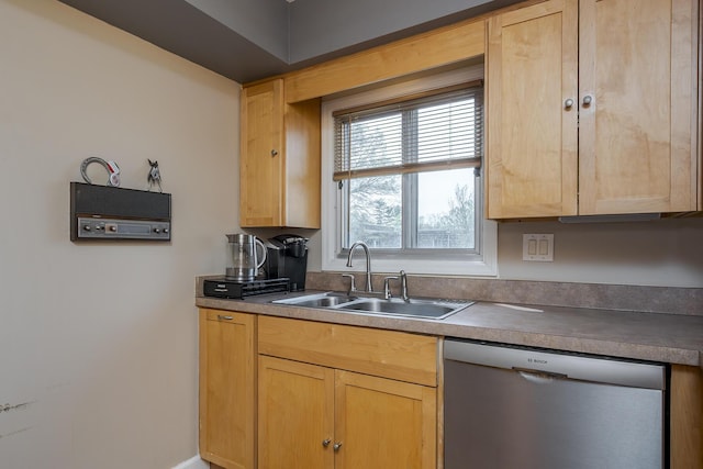 kitchen featuring stainless steel dishwasher, light brown cabinetry, and a sink