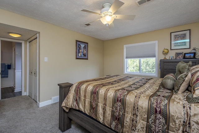 carpeted bedroom with baseboards, a ceiling fan, a textured ceiling, and visible vents