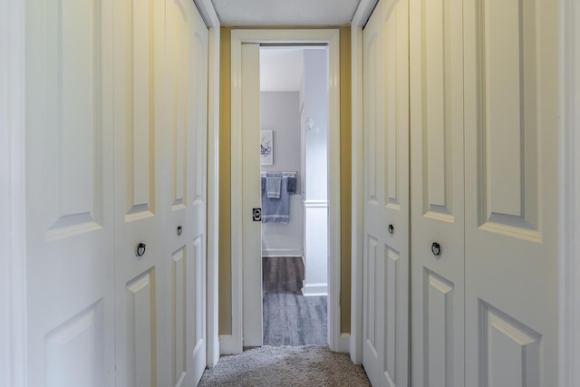 corridor featuring carpet floors and baseboards