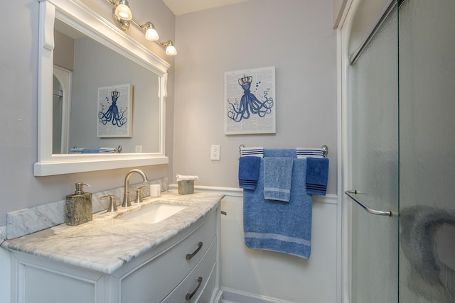 full bath with a shower with door and vanity