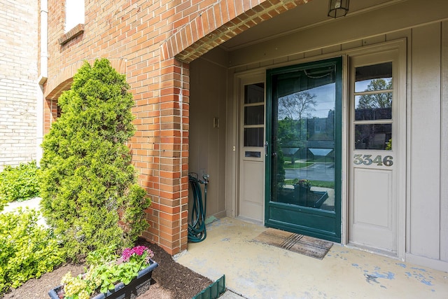 doorway to property with brick siding